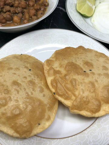 Two Deep fried puri or Indian puffed bread served in a plate