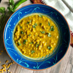 chana dal in a bowl garnished with cilantro.