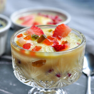 indian custard in a bowl with fruits and tutti frutti
