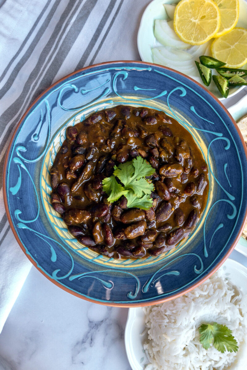 instant pot rajma in a bowl with rice in bacground