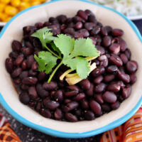 black beans in a blue and white bowl.