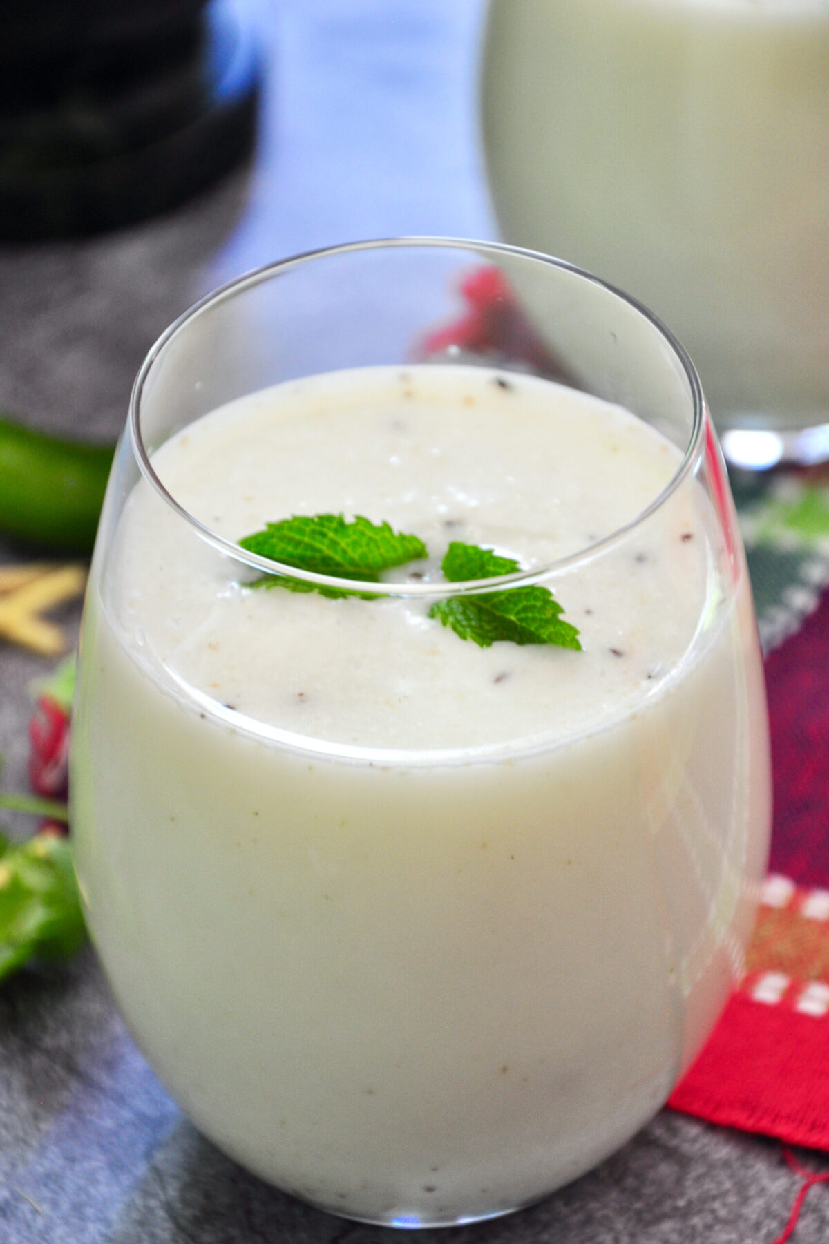 buttermilk in a glass and garnished with mint leaves