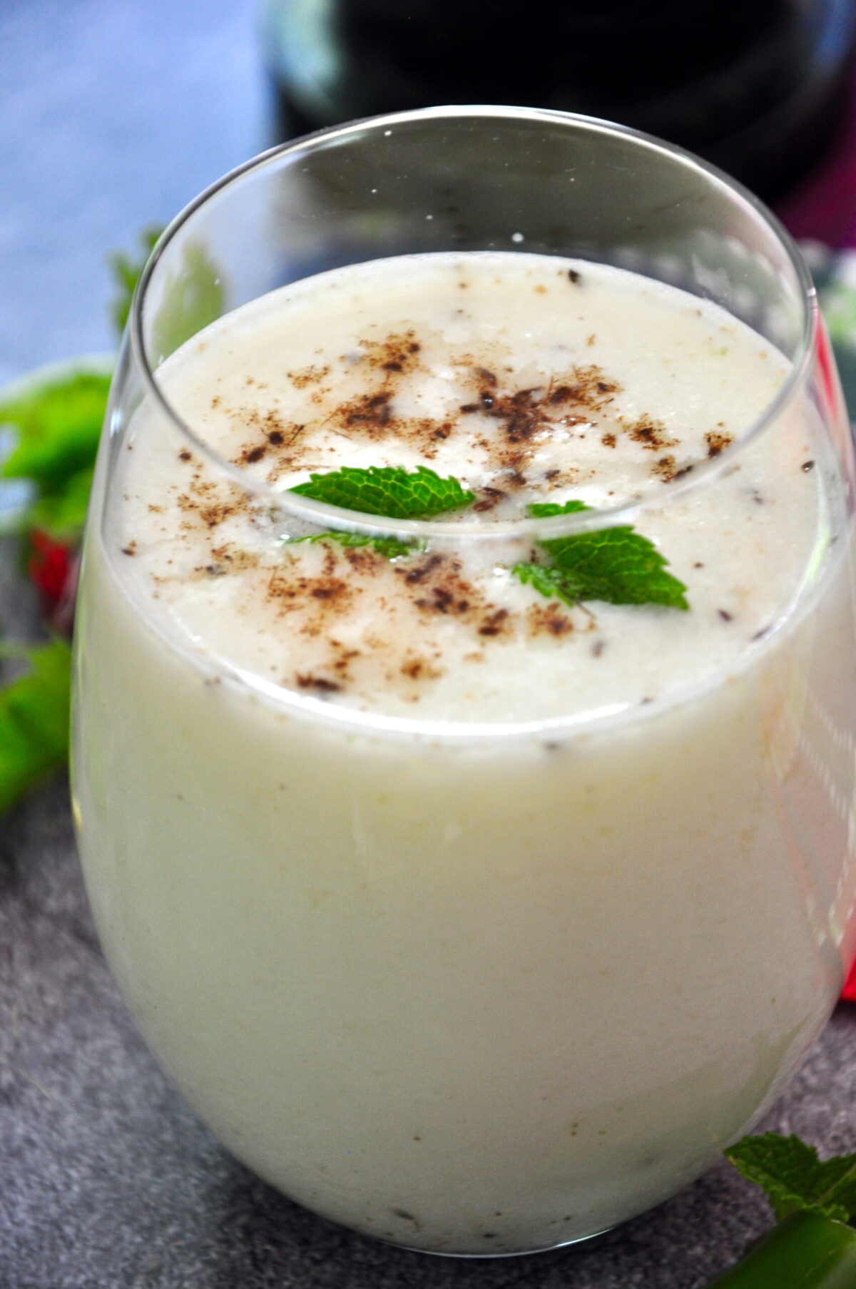 buttermilk in a glass and garnished with roasted cumin powder and mint leaves
