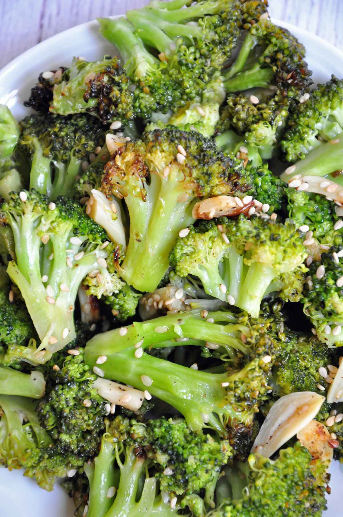 Air fried broccoli in a plate and garnished with sesame seeds.