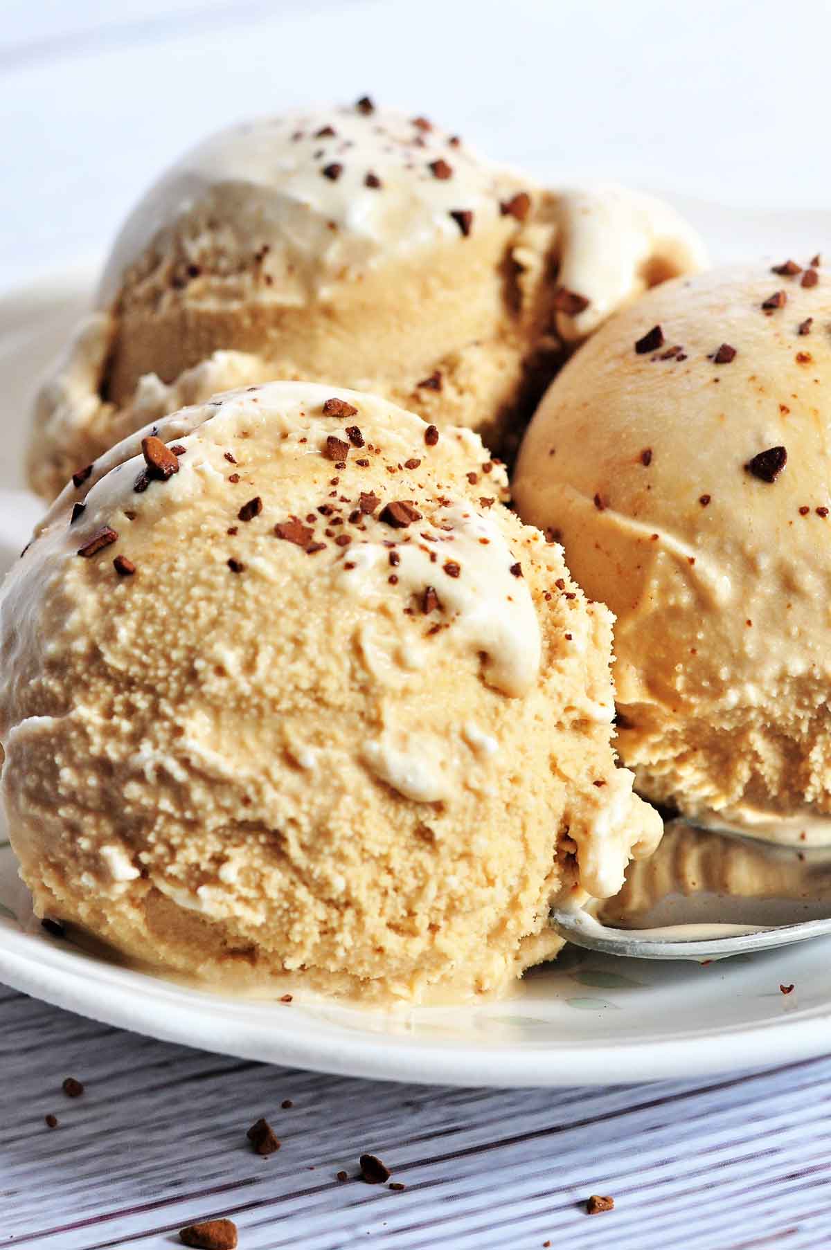 Three scoops of coffee ice cream in a plate.
