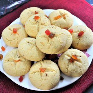 nankhatai served in a tray topped with candied fruit pieces.