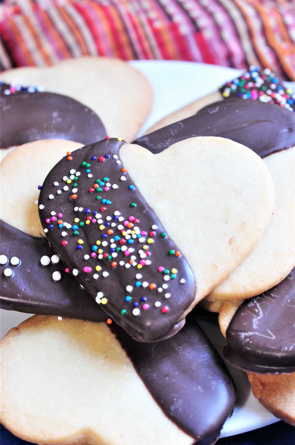 Chocolate dipped heart shaped cookies with sprinkle topping.