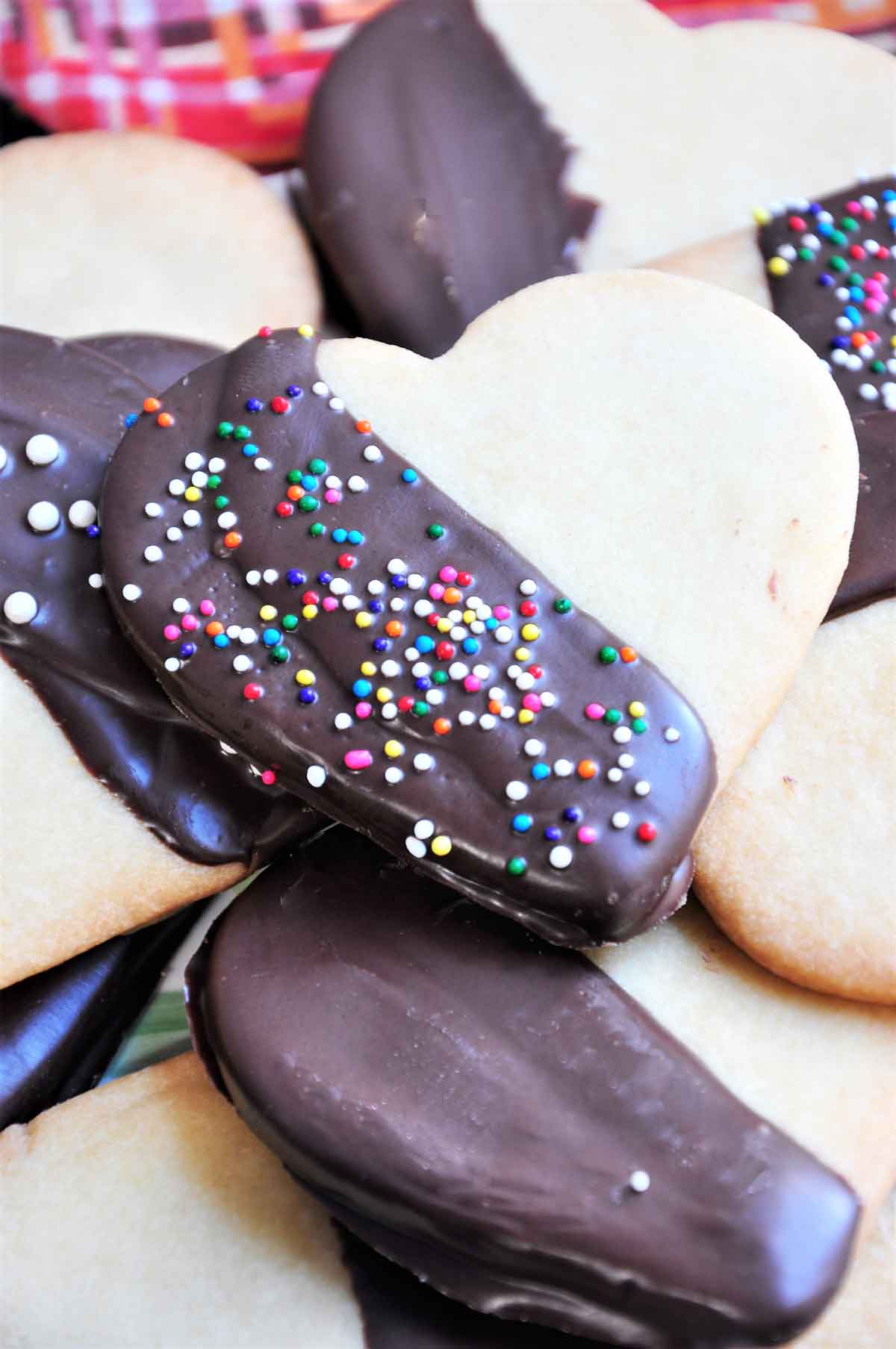 Chocolate dipped heart shaped cookies with sprinkle topping.