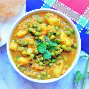 Potato and peas curry served in a bowl.