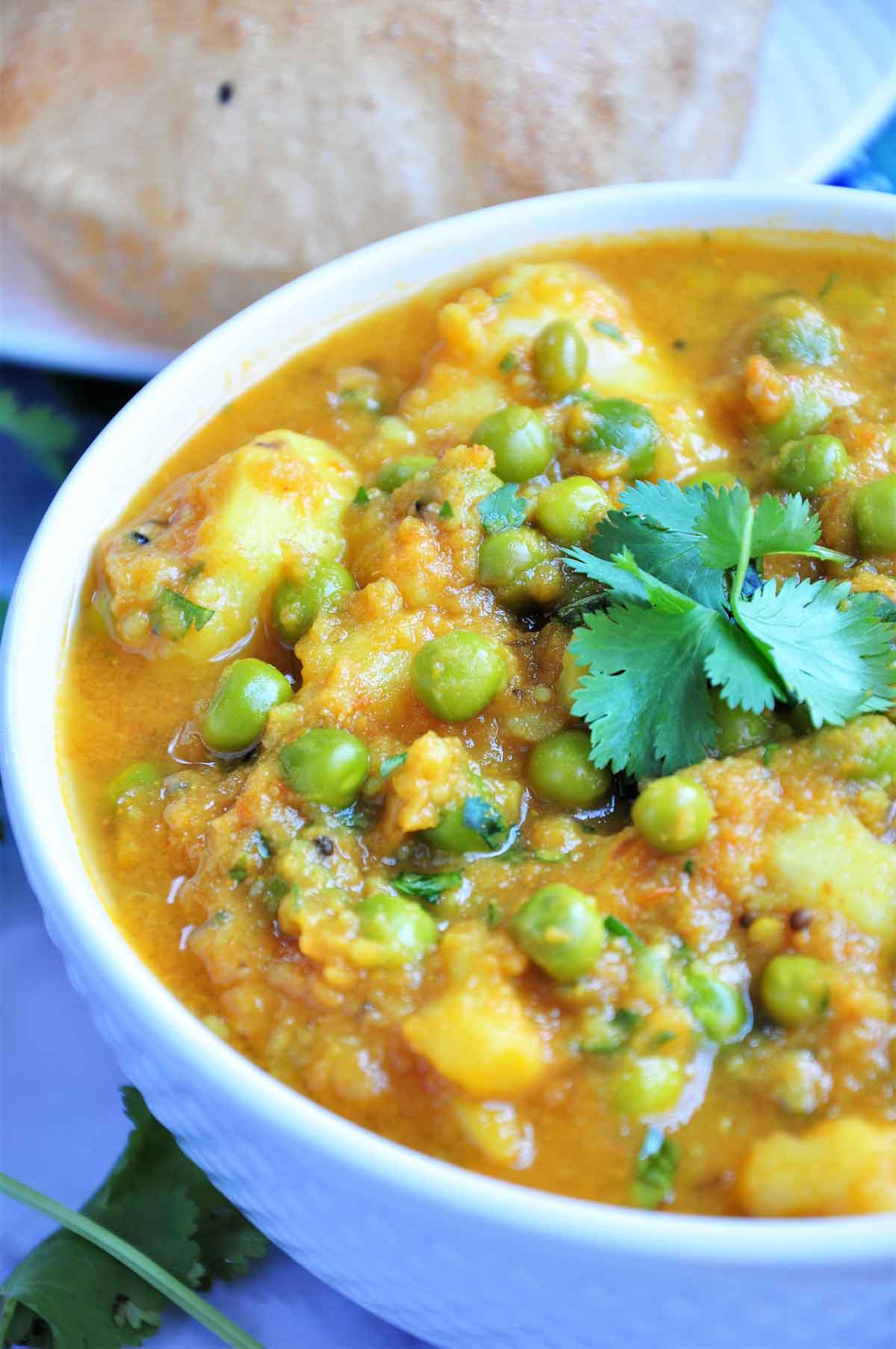 Potato and peas curry served in a bowl.