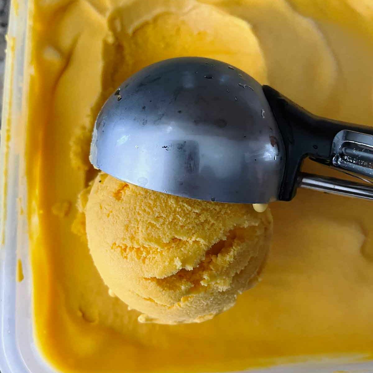 Scoop mango ice cream and serve.