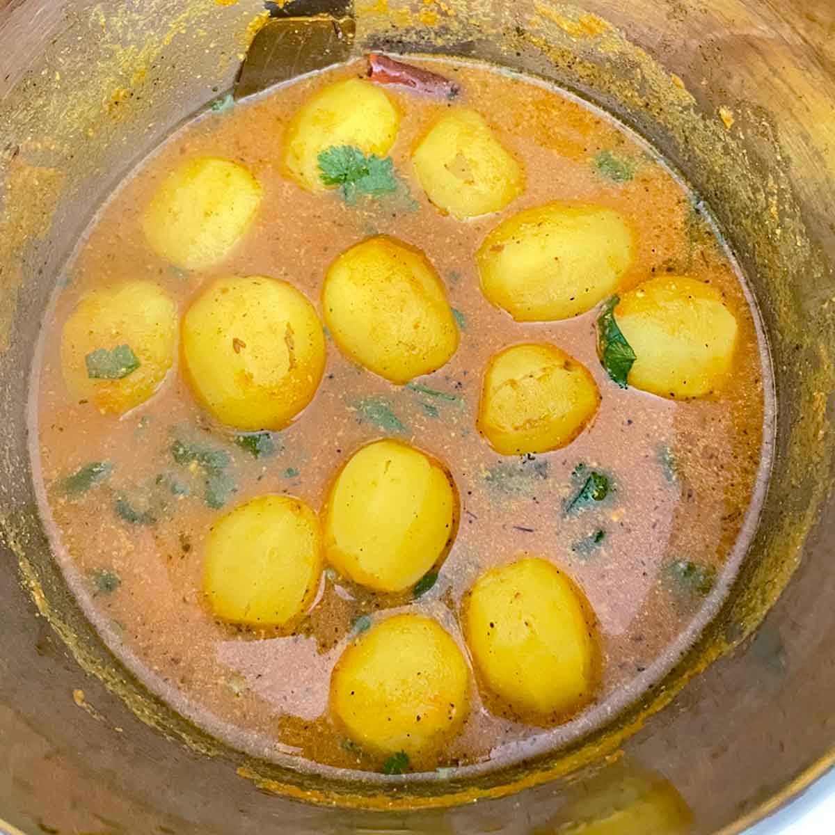 Dum aloo garnished with cilantro in instant pot.