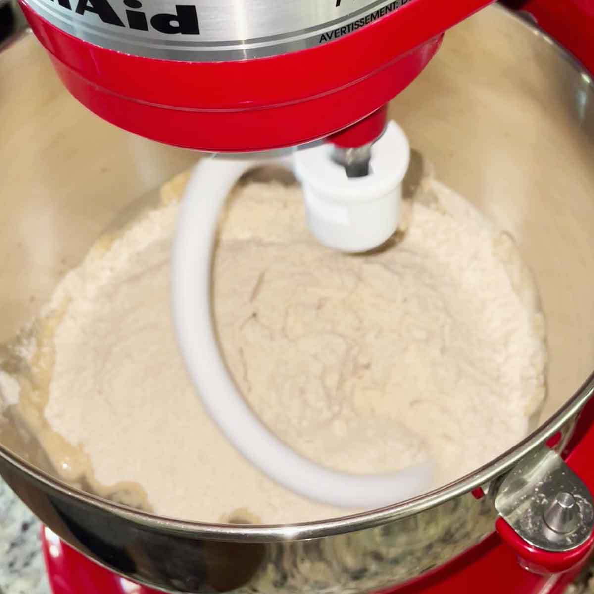 Bowl attached to stand mixer for kneading.