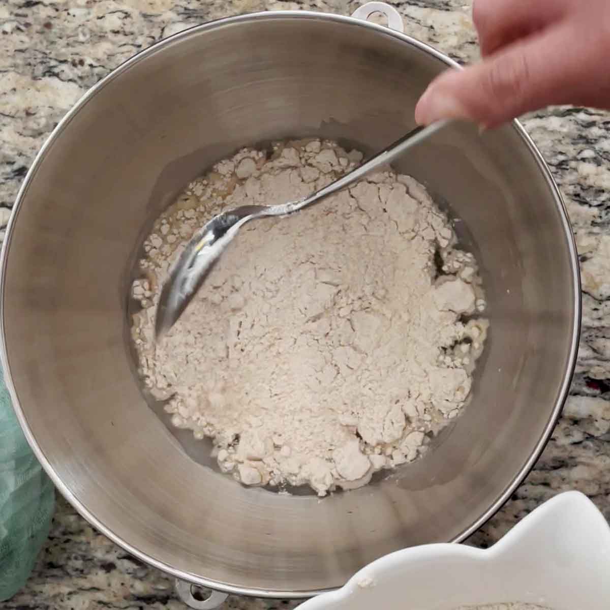 Weighing flour for roti dough.
