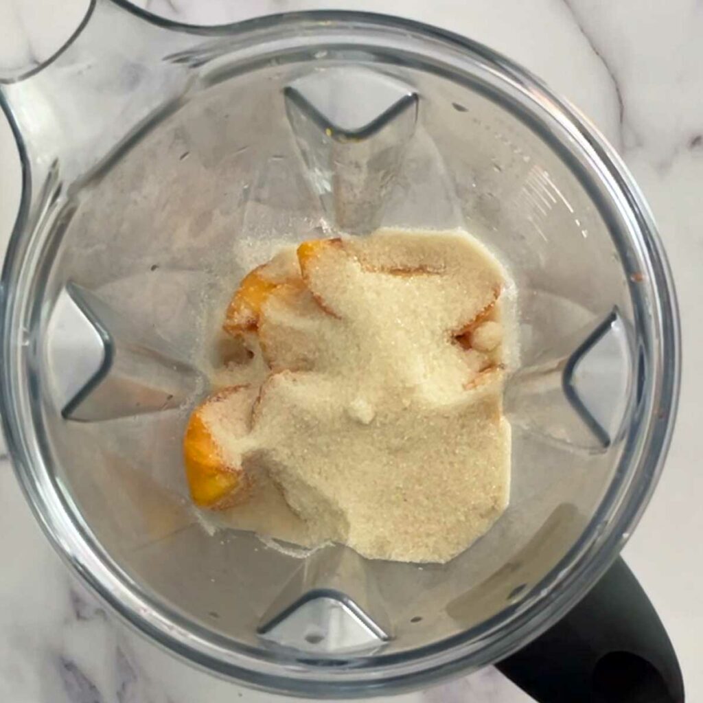 Peach ice cream ingredients in a blender.
