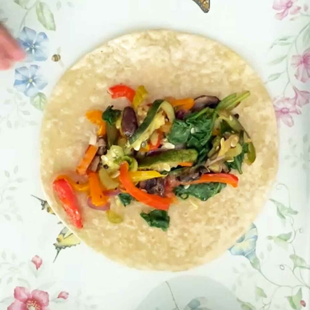 Veggies placed on a tortilla for wrap.