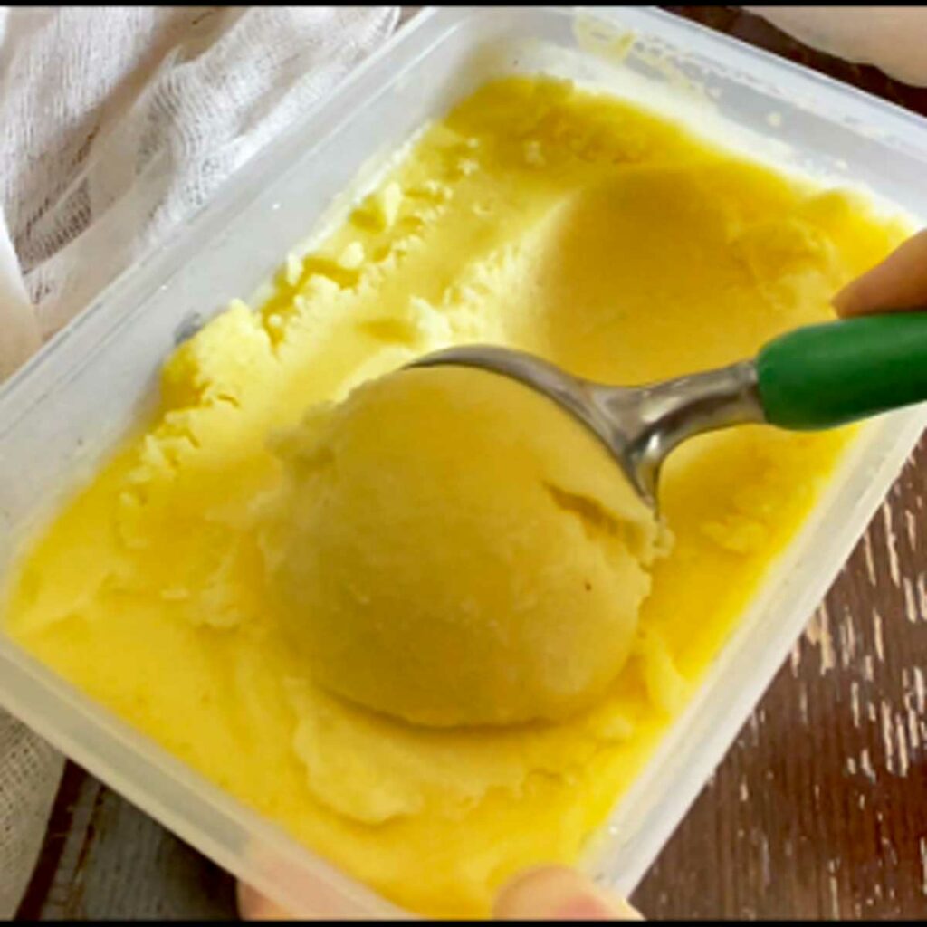 Scoop pineapple sorbet ice cream.