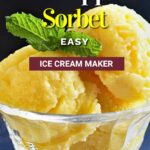 pineapple sorbet ice cream scoops in a glass stem bowl.
