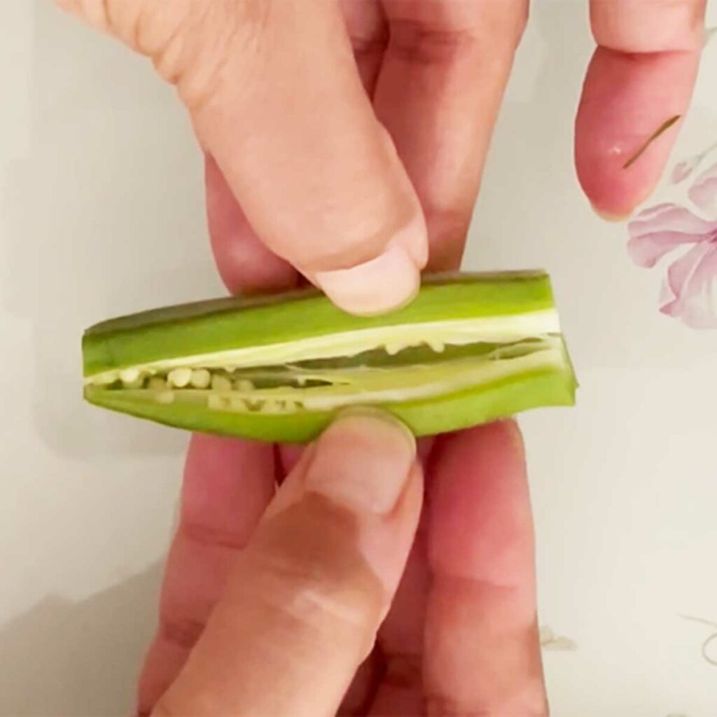 Splitting okra along length for stuffed okra.