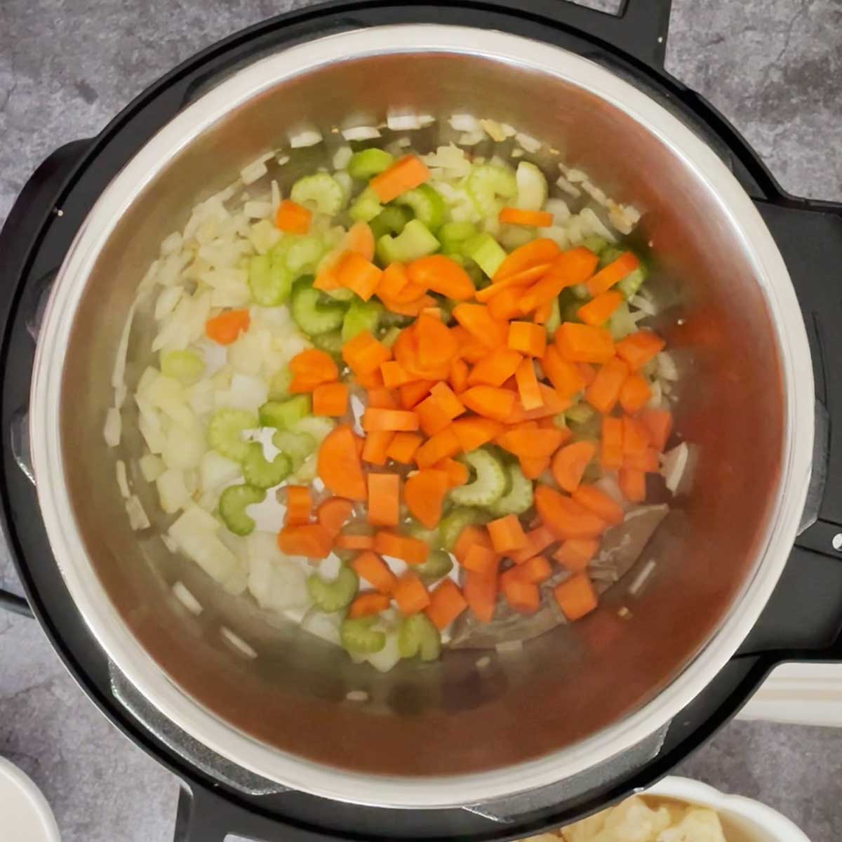 Sautéed vegetables for cauliflower soup in instant pot.