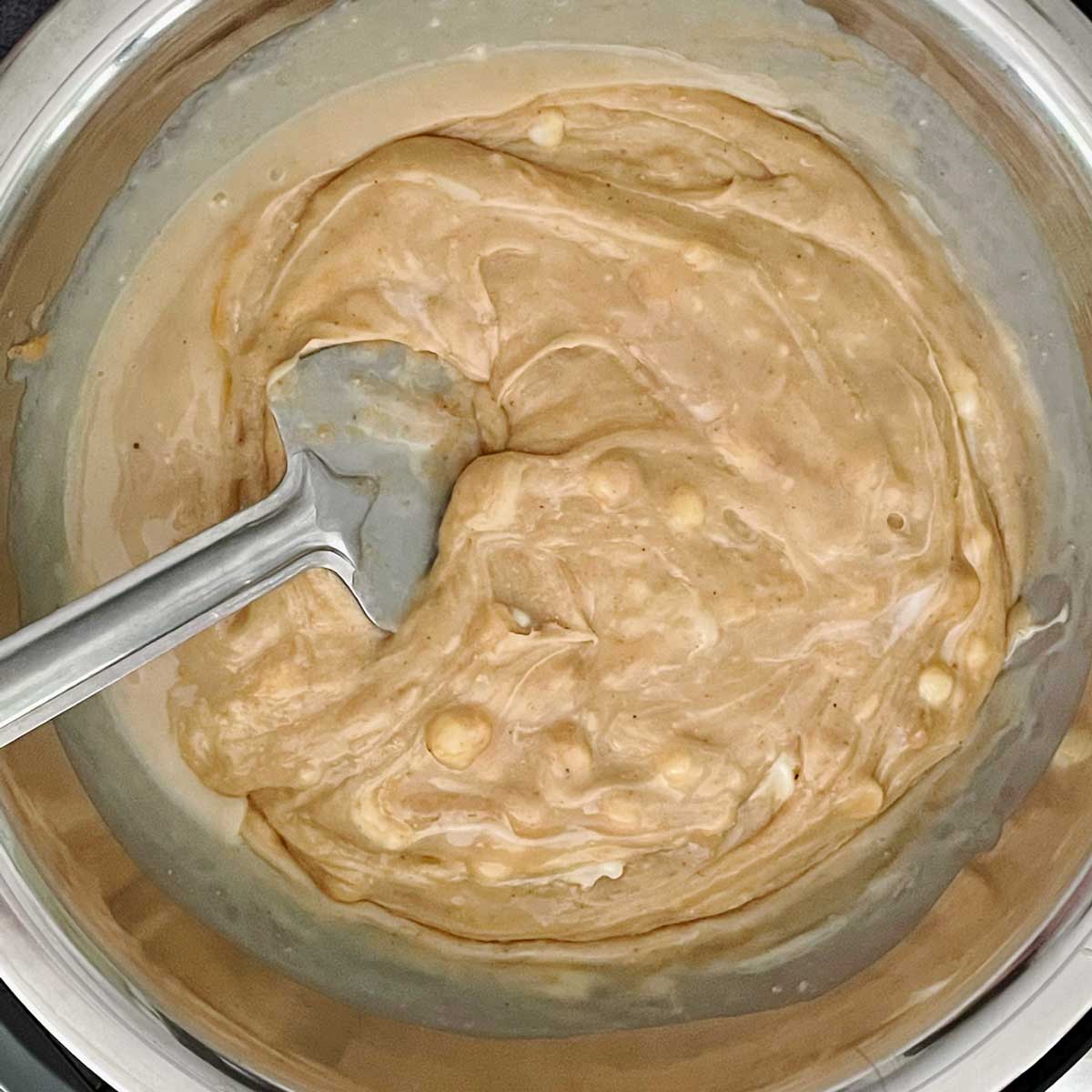 Peanut butter fudge mix in a steel bowl.
