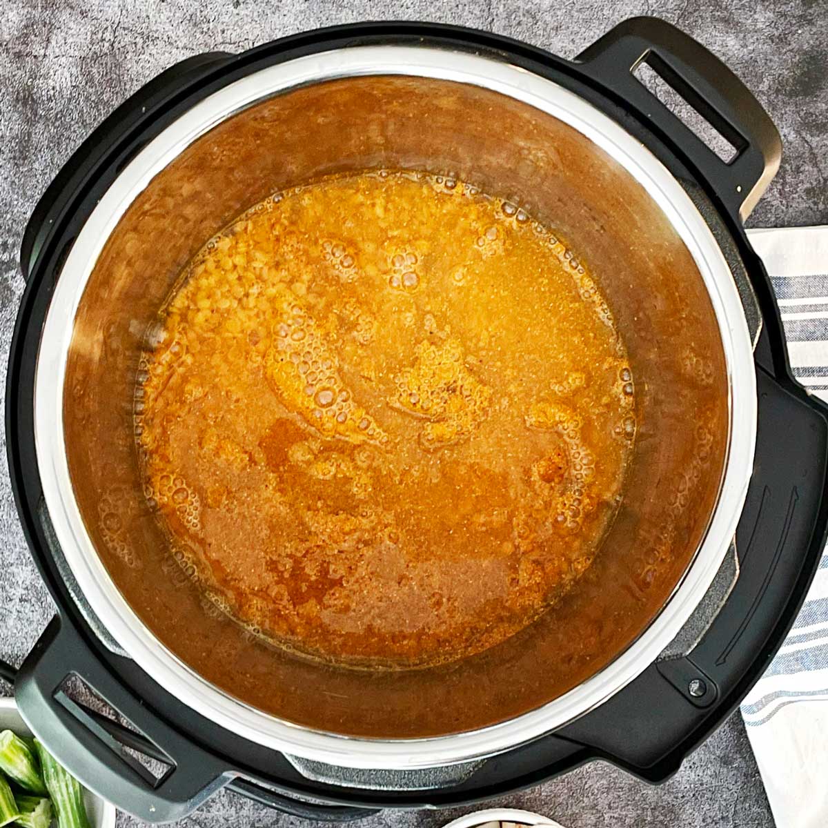 Dal, water, and spices in instant pot liner.