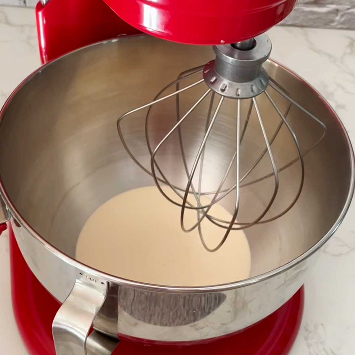 Cream in a stand mixer bowl.