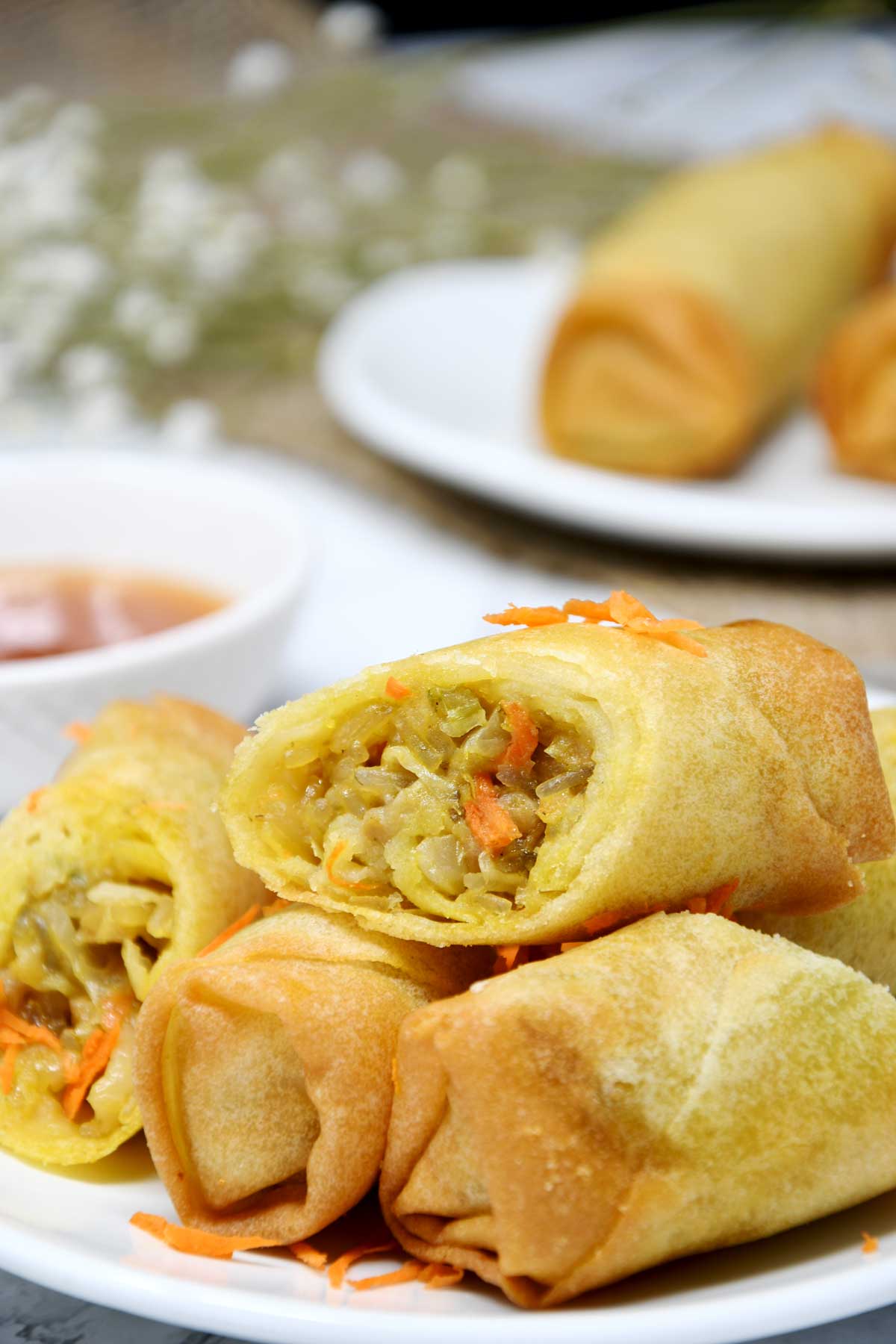 Air fryer frozen spring rolls served with sweet sauce.