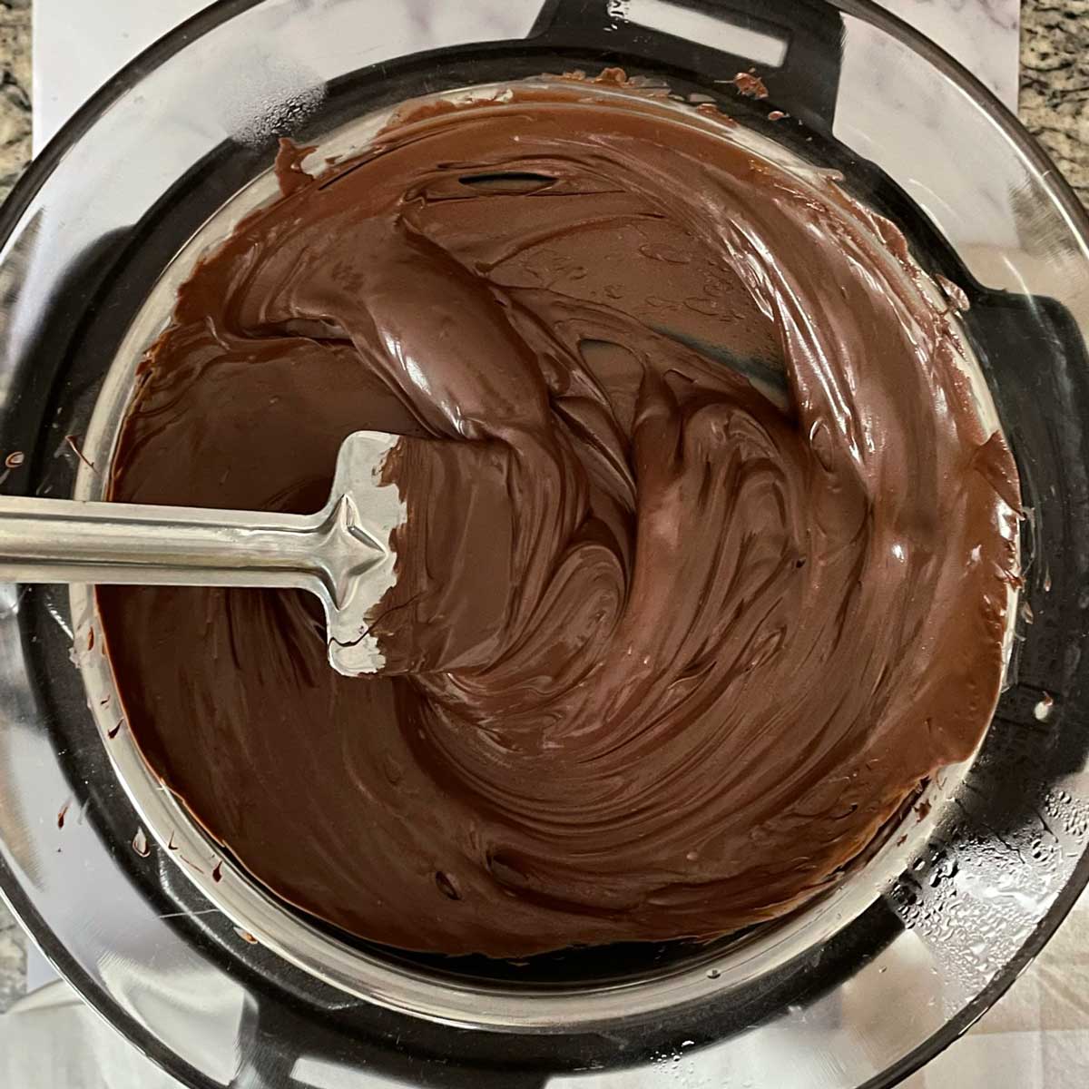Melted chocolate over a pot.