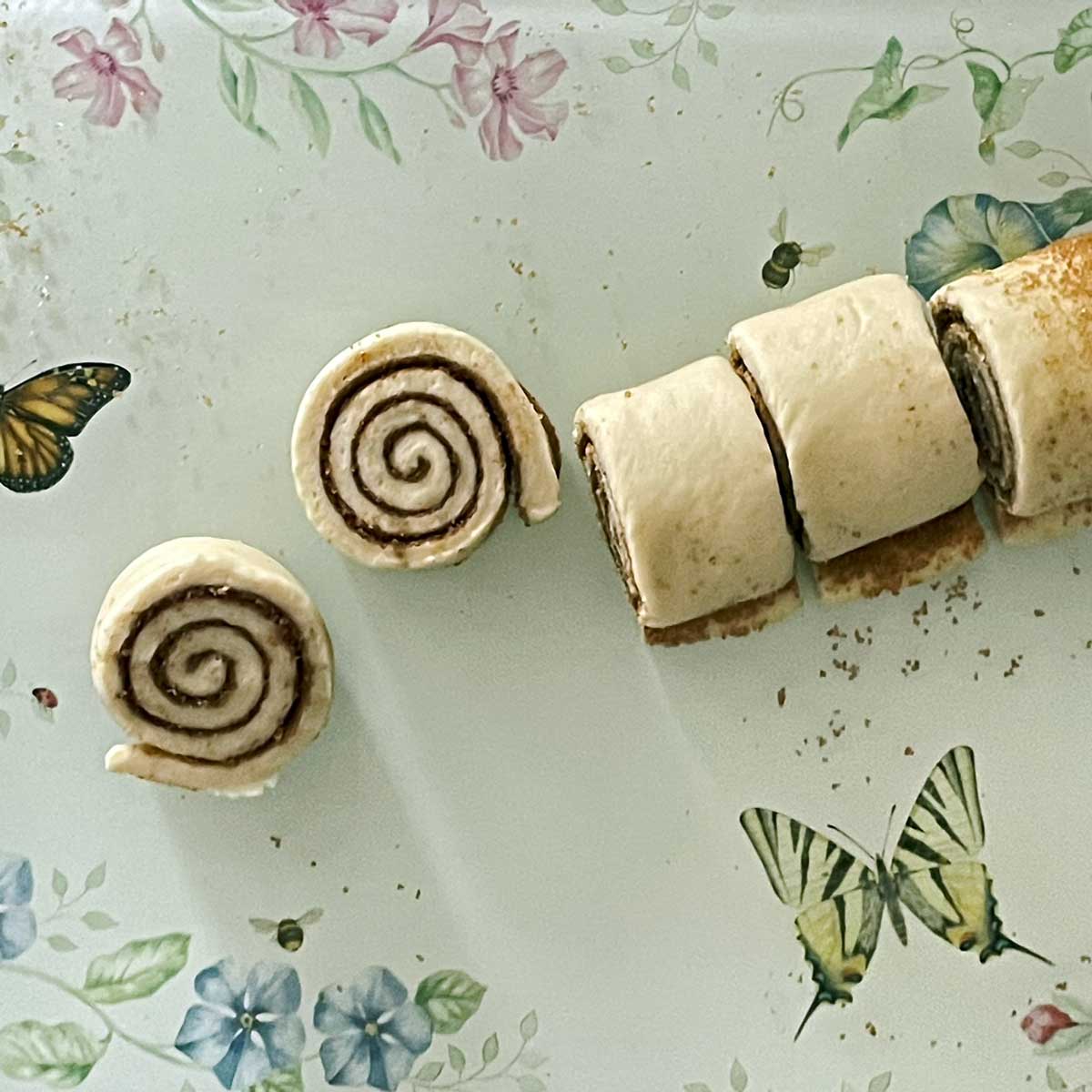 Cinnamon rolls dough cut into wheels.