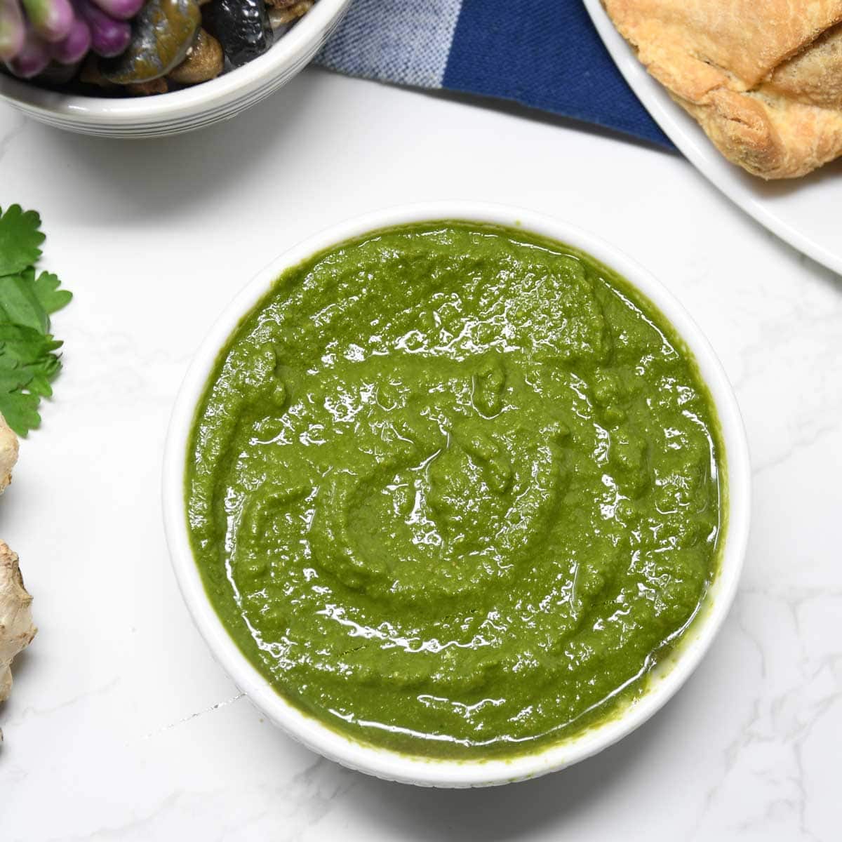 Green chutney served in a bowl.