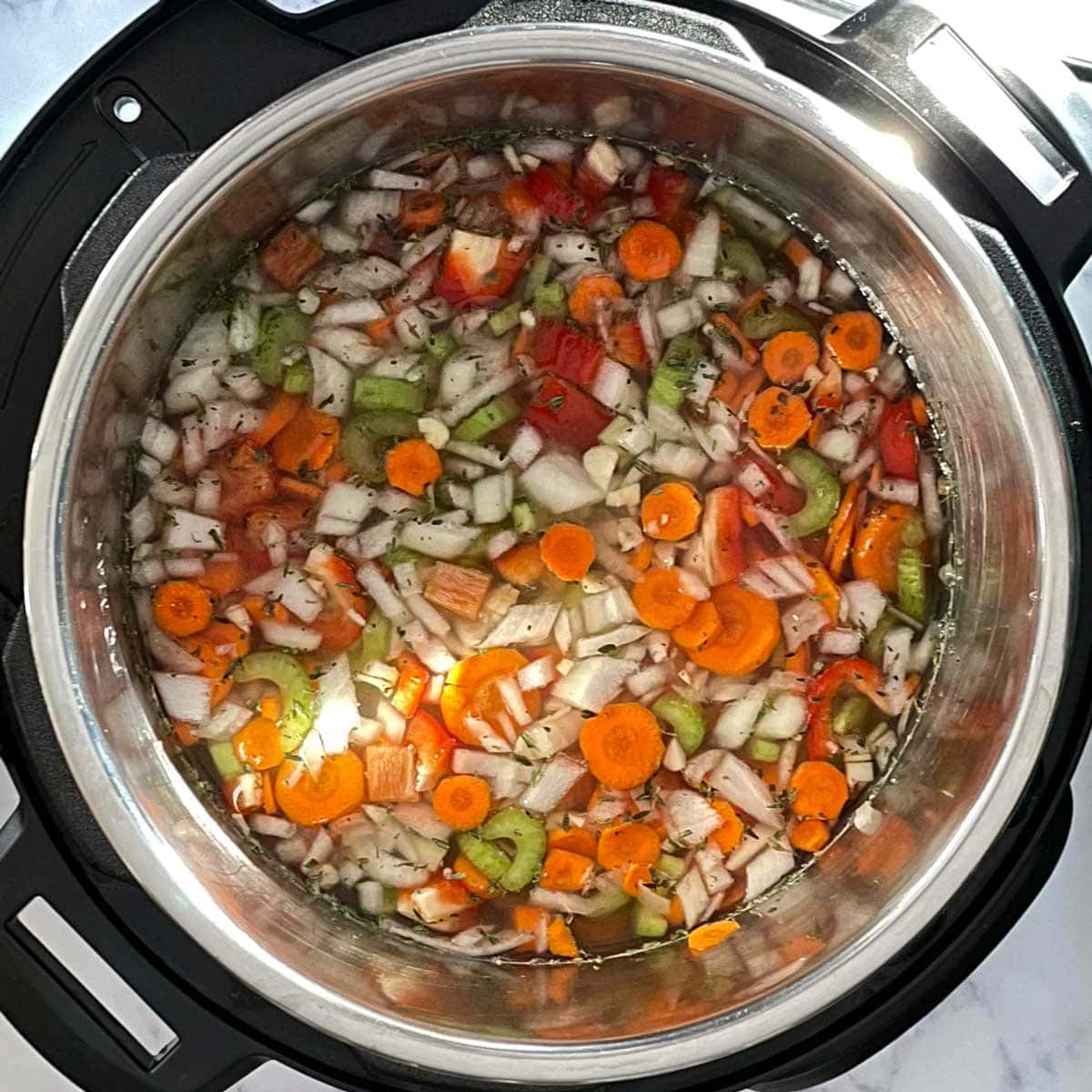Split peas soup ingredients with water in instant pot.