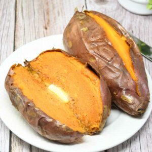 Air fryer baked whole sweet potato served in a plate.