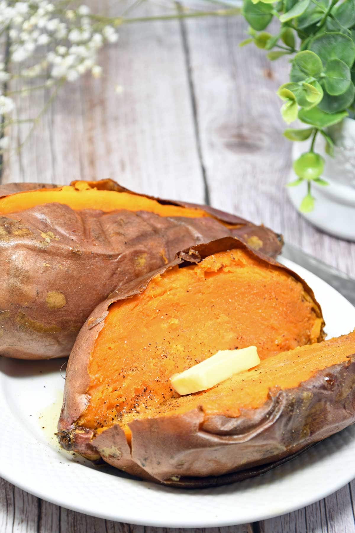 Air fryer baked whole sweet potato served in a plate.