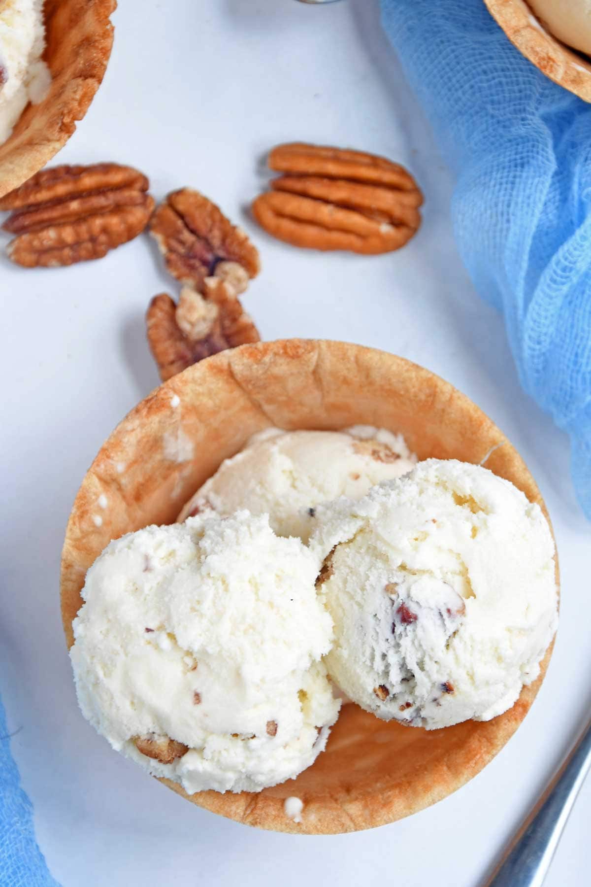 Butter Pecan ice cream scoops in a waffle cup.