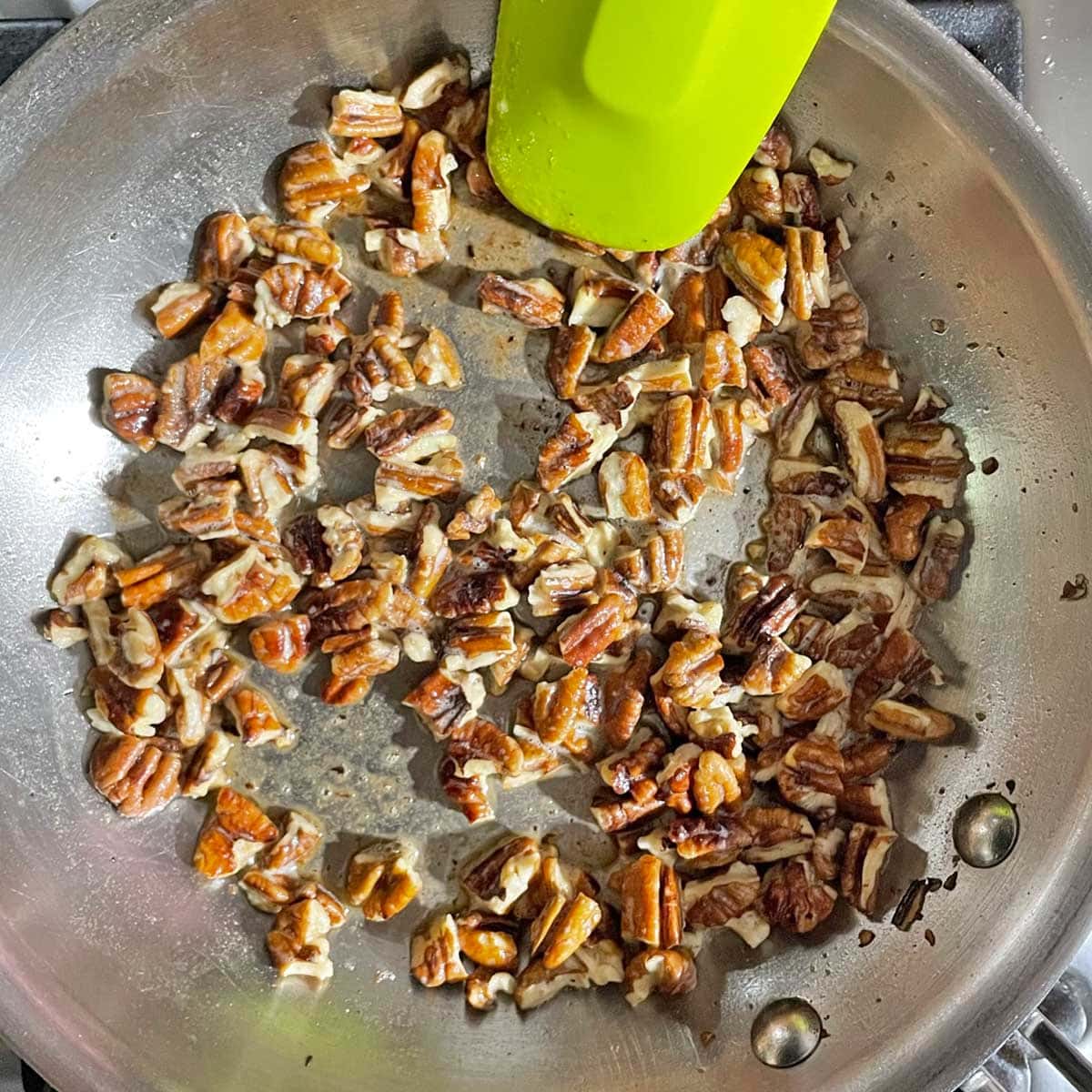 Roasting Pecan in butter in a skillet.