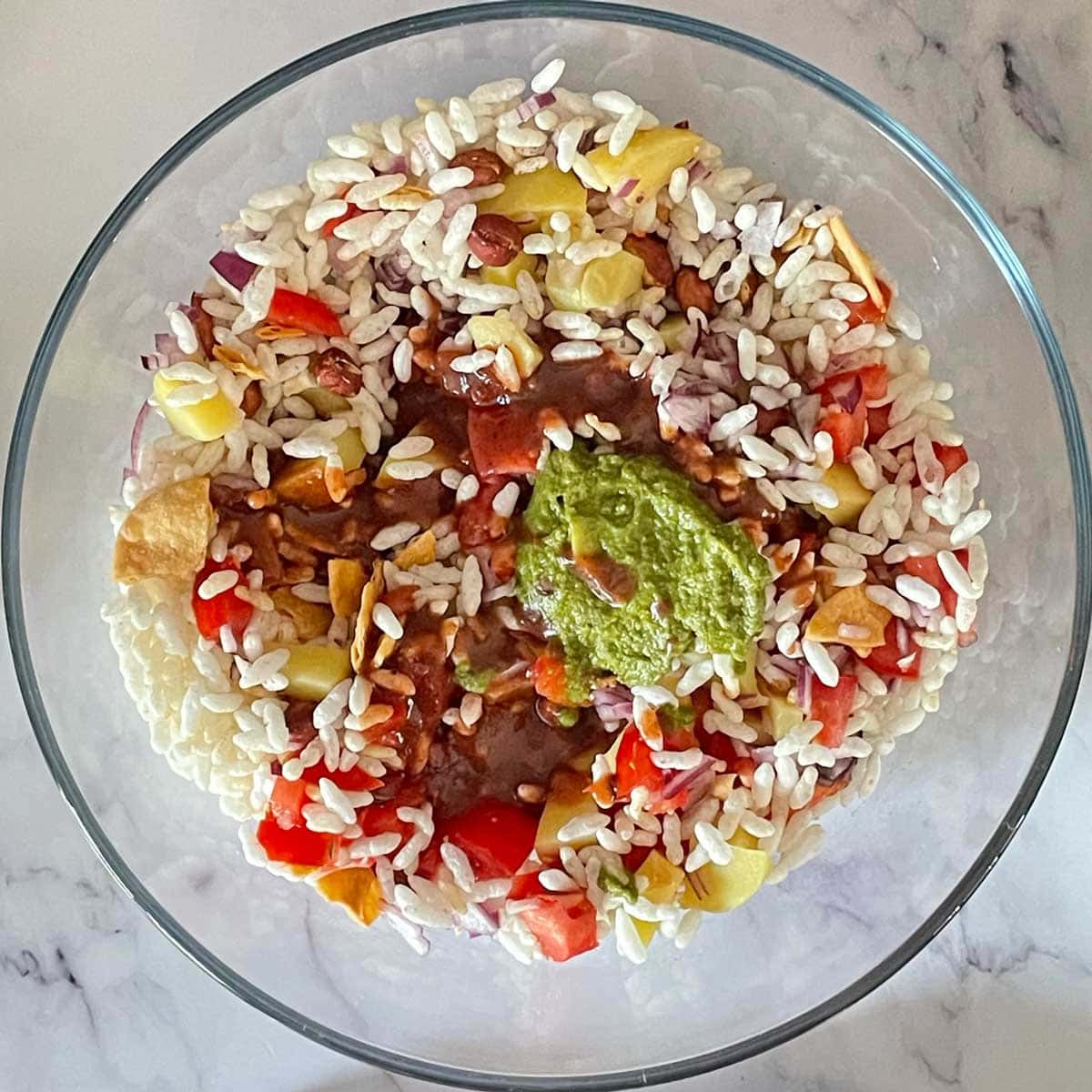 Bhel chutney mix in a glass mixing bowl.