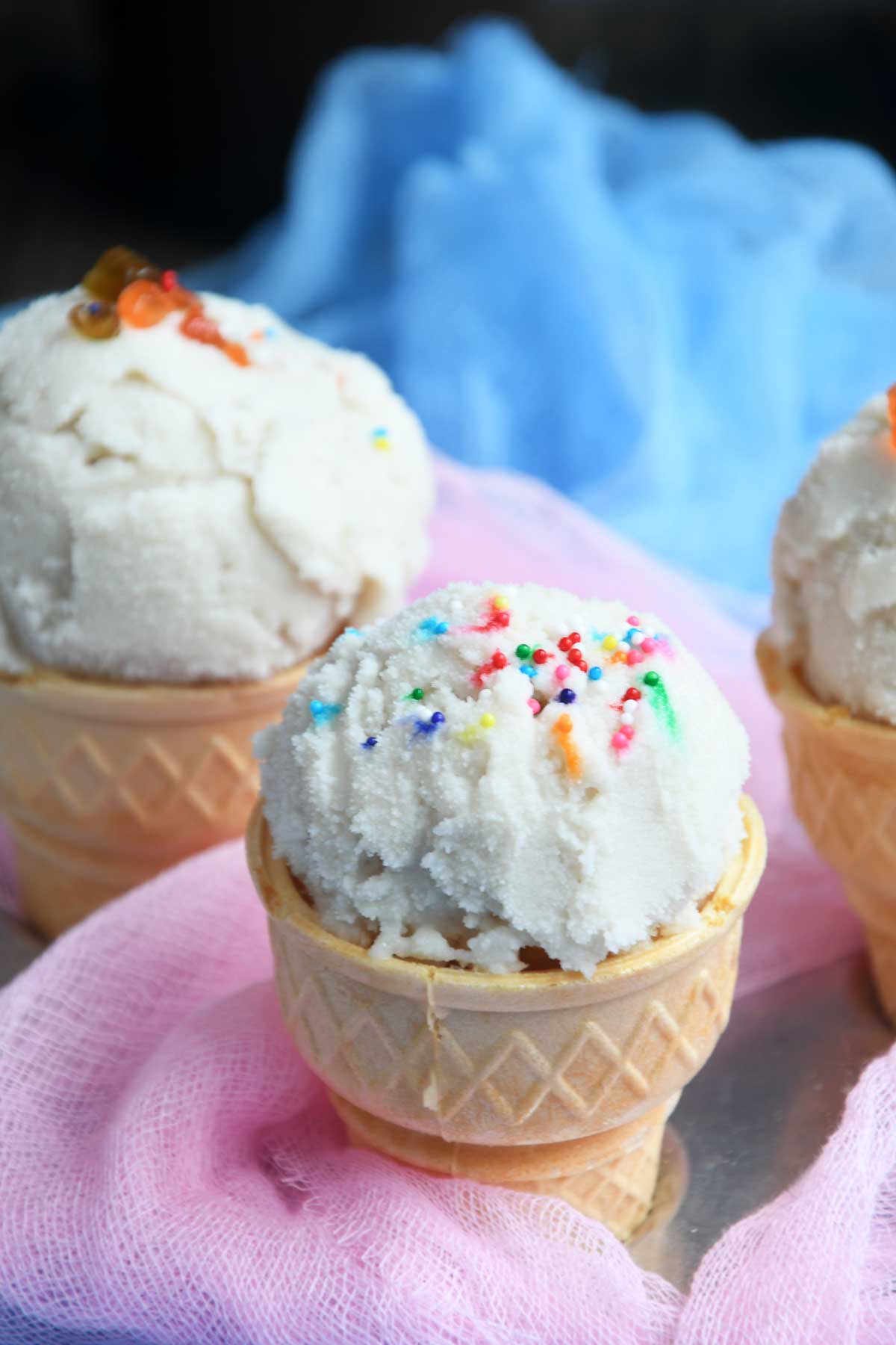Vegan vanilla ice cream scoops served in cones.