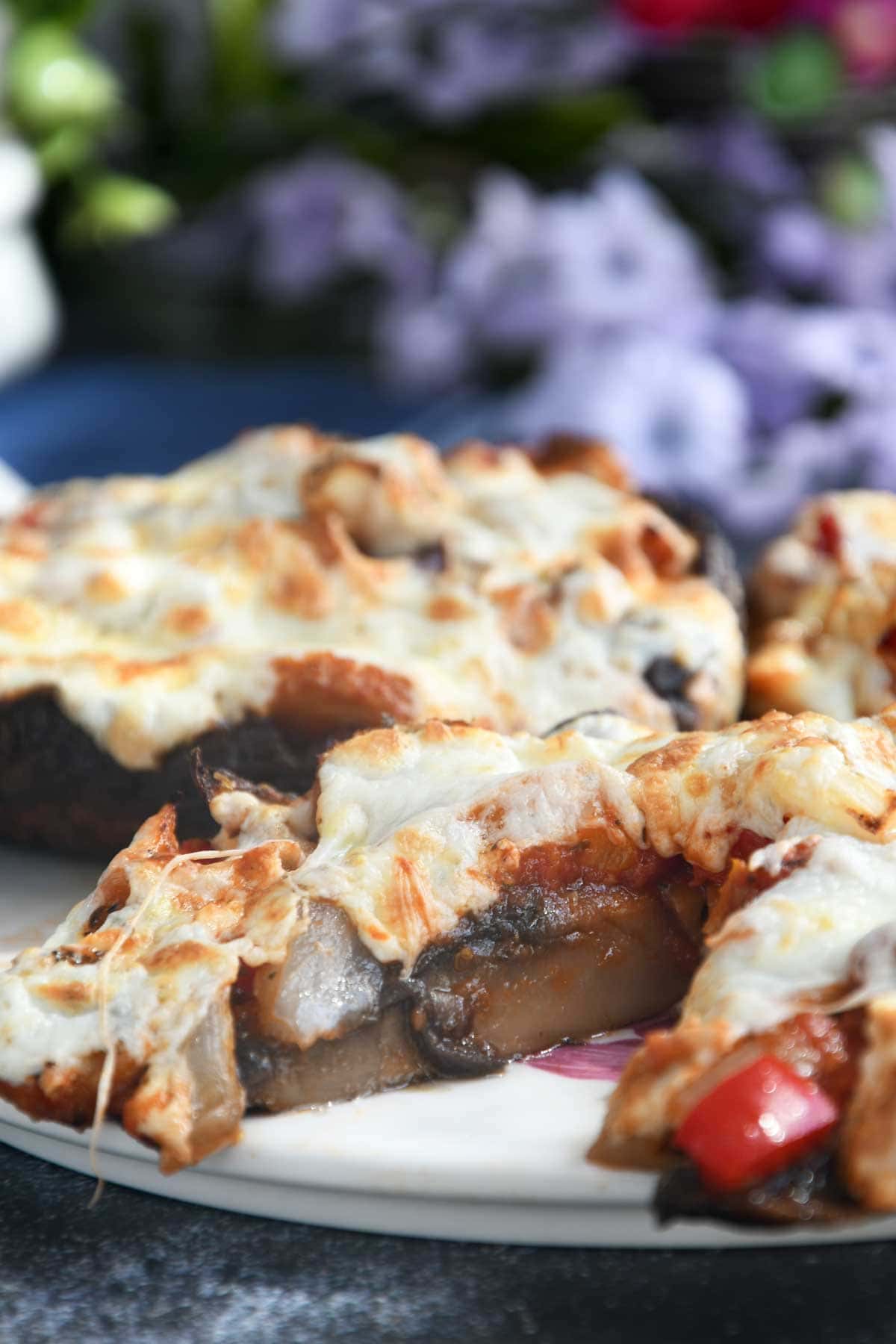 Portobello mushroom pizza served on a platter.