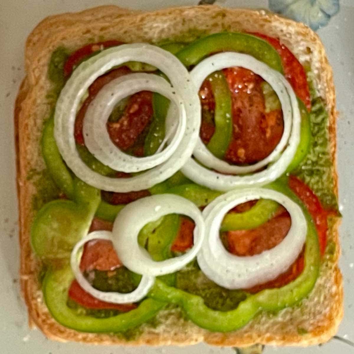 Mumbai sandwich layered with cut vegetables.