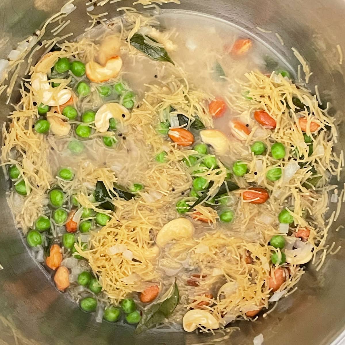Sauted ingredients with water for Vermicelli Upma.