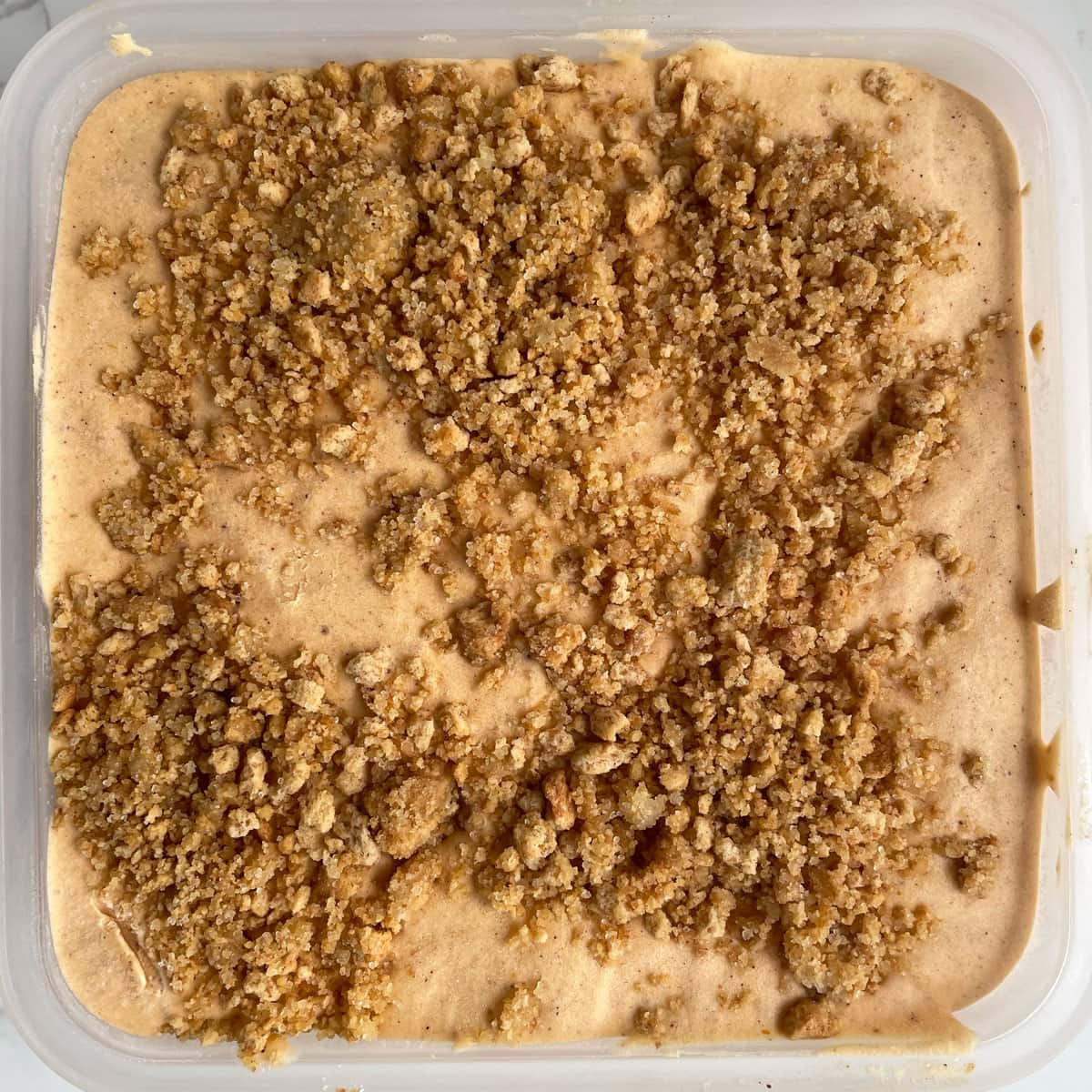 Pumpkin cheesecake ice cream in container.