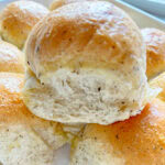 Herb dinner roll in a baking tray.