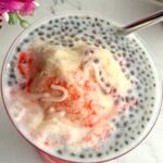 Falooda ice cream in a tall glass with straw.