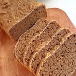 Sprouted wheat flour bread slices on a cutting board.