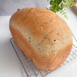 Everything Seasoning bread loaf on a cooling rack.